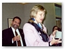 Vera Skop, Manager of Reference Services, Greenwich Library, opens a gift at her retirement party, as Mario Gonz&aacute;lez, Library Director, looks on.